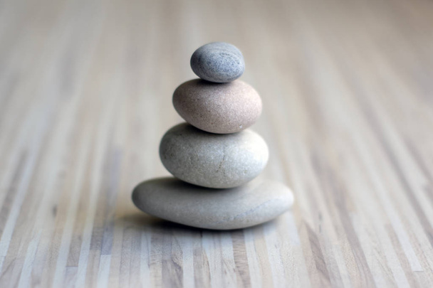 Stone cairn on striped grey white background, three stones tower, simple poise stones, simplicity harmony and balance, rock zen sculptures - Fotoğraf, Görsel