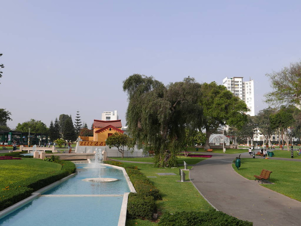 Scenic view of a river flowing water fountain that ends in a yellow and red house located in  the Magic Water Circuit in Lima public Reverve Park. It is the world's largest fountain complex in a park, making it worthy of the Record Guinness Award - Photo, Image