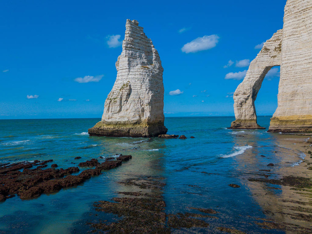 Chalk cliffs of Etretat with the natural arch Porte dAval and the stone needle called LAiguille - Fotografie, Obrázek