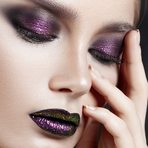 Young beautiful girl with purple make-up. Beauty close-up portrait - Fotó, kép