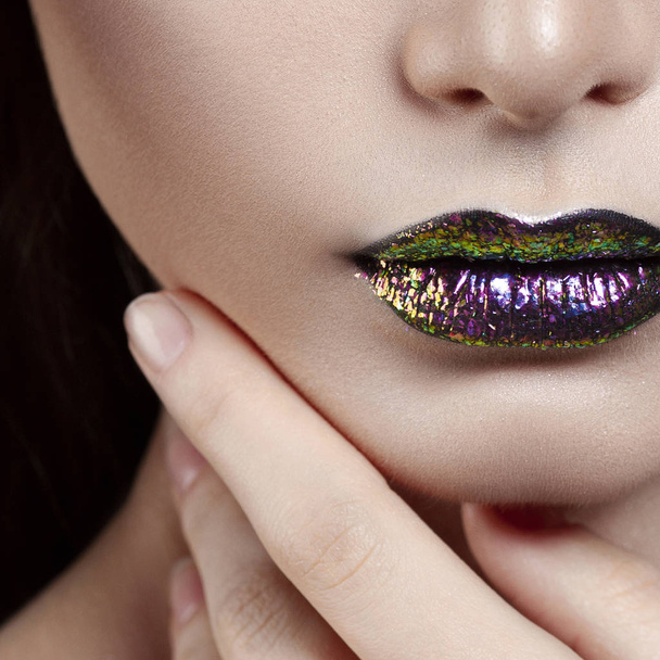 Young beautiful girl with purple make-up. Anonymous beauty close-up portrait - 写真・画像