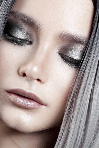 Young beautiful girl with silver make-up and ash hair. Beauty close-up portrait - 写真・画像