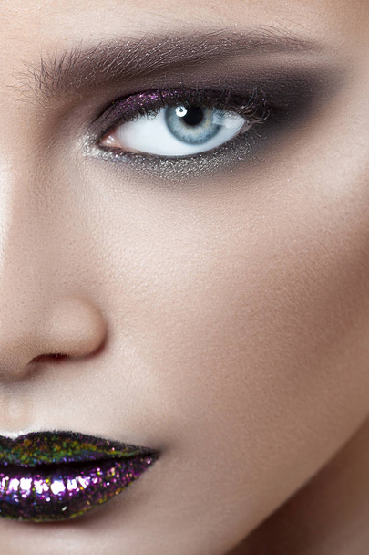 Young beautiful girl with purple make-up. Beauty close-up portrait - Valokuva, kuva