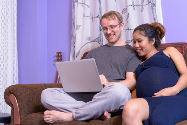 Multi-ethnic couple married and in love in the living room - Photo, Image