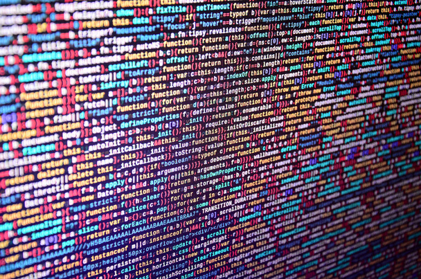 Software developer programming code on computer. Abstract computer script source code. Shallow depth of field, selective focus effect - Photo, Image