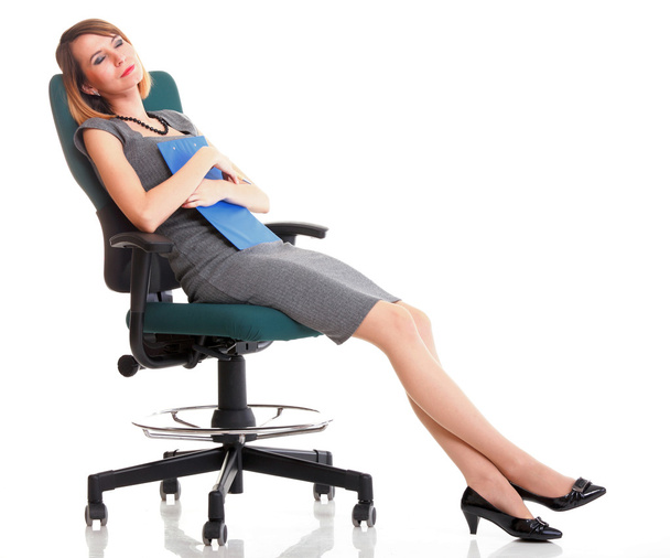 Full length business woman sitting on chair holding clipboard is - Fotó, kép