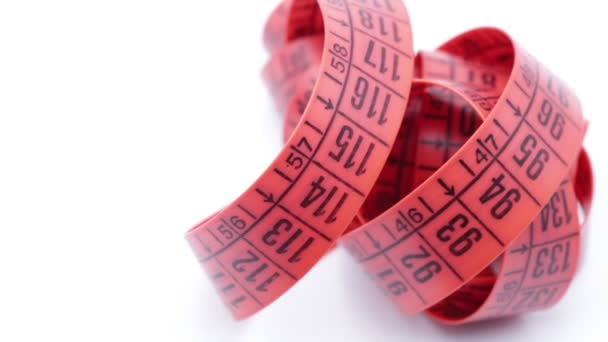 cinta métrica roja sobre fondo blanco, como el concepto de dieta y longitud
  - Imágenes, Vídeo