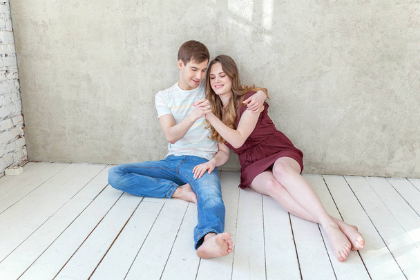 Young couple in love. Couple supporting each other and relying on each other having nice time together. Young happy woman hugging her handsome boyfriend. Portrait of cheerful casual people in love, students having hopes, dreams, goals, bride and groo - Фото, изображение