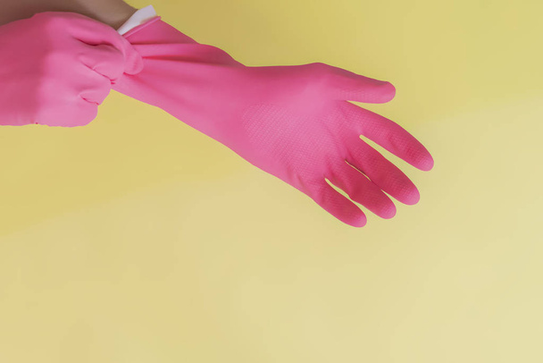 isolated female housekeeper hands put on pink gloves wih copy space f - Photo, Image