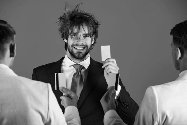 Happy businessman smiling with happy face and card in hand - Foto, imagen