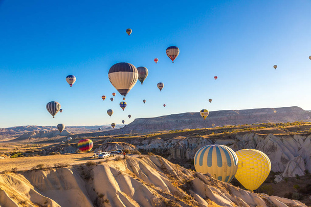 CAPPADOCIA, TURKEY - JULY 29, 2017: Hot air Balloons flight in Cappadocia, Nevsehir, Turkey in a beautiful summer day - Φωτογραφία, εικόνα