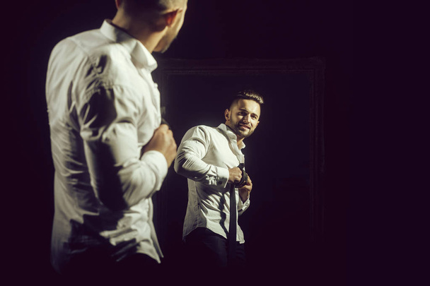 muscular macho man in white shirt near vintage mirror - 写真・画像