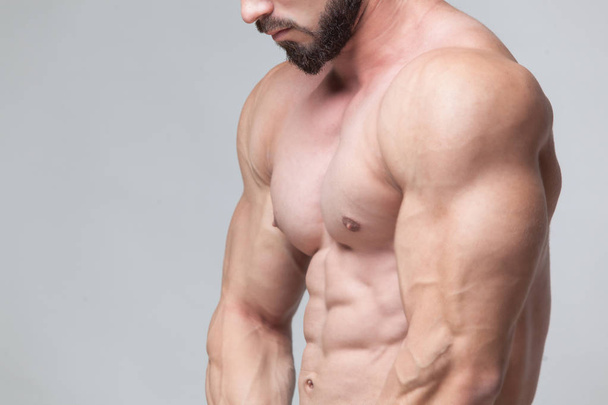 Strong Athletic Man Fitness Model Torso showing six pack abs. isolated on grey background with copyspace - Foto, immagini