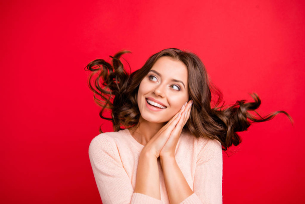 Dynamic image. Close up portrait of person with wave hairdo look aside make big toothy white smile isolated on shine red background - Foto, Imagen