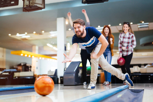 Friends bowling at club and having fun playing casually - Photo, Image