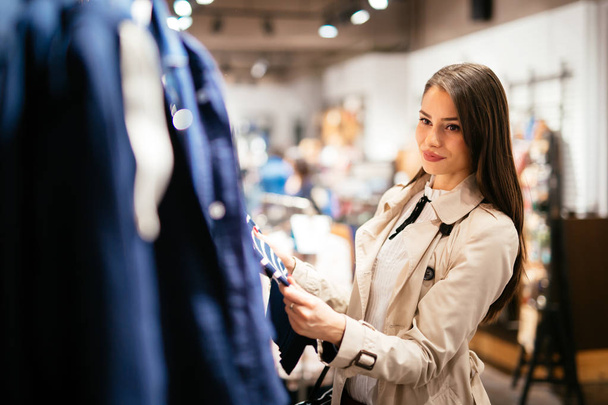 Beautiful young cute brunette businesswoman buying clothes - Foto, imagen