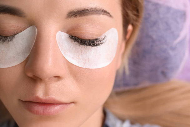 Young woman undergoing eyelash extensions procedure, closeup - Foto, Imagem