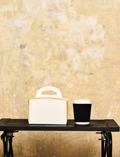 black and white tea or coffee paper cup for drink ladies handbag tray on beige textured background, copy spac - Fotó, kép