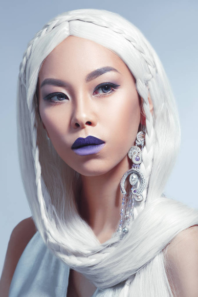 Beauty portrait of a beautiful Asian girl with long white hair isolated on a gray background. - Foto, immagini