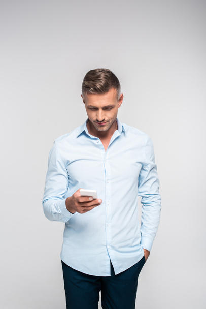 handsome adult man using smartphone isolated on white - Φωτογραφία, εικόνα