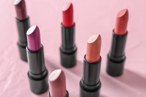 Lipsticks of different shades on color background - Foto, immagini