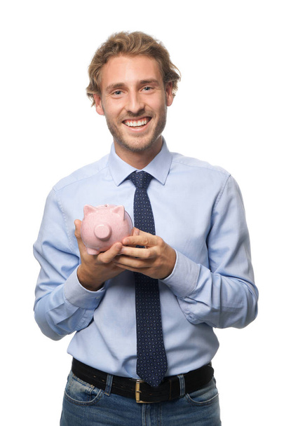 Handsome man with piggy bank on white background - Фото, зображення