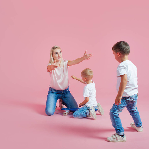 Beautiful blonde mom with two sons. Young woman and two baby boys - Фото, изображение
