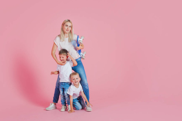 Beautiful blonde mom with two happy sons. Young woman and two baby boys - Fotografie, Obrázek