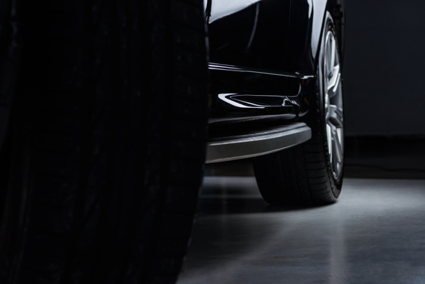 közelről view luxus csillogó fekete autó, sötét háttér - Fotó, kép