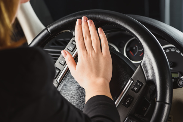 cropped shot of woman honking horn while driving car - Photo, Image