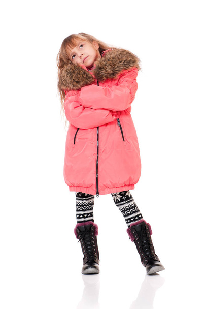 Little girl dressed with winter clothes - Fotó, kép