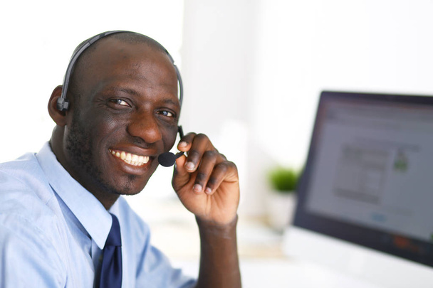 African american businessman on headset working on his laptop - Φωτογραφία, εικόνα