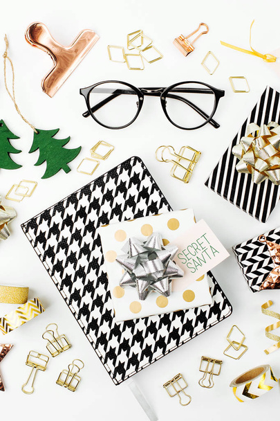 Christmas winter decorations, business stationery and gifts from secret Santa on white background. Office celebration concept. Flat lay, top vie - Φωτογραφία, εικόνα