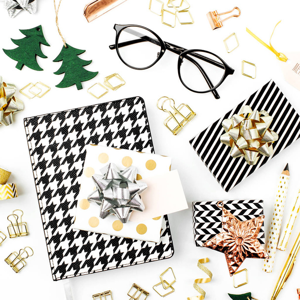 Christmas winter decorations, business stationery and gifts from secret Santa on white background. Office celebration concept. Flat lay, top vie - 写真・画像