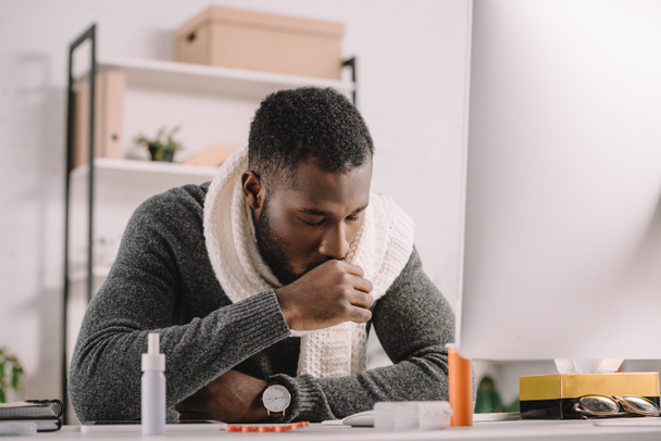 barbudo afroamericano enfermo empresario tosiendo en el lugar de trabajo con medicamentos
 - Foto, imagen