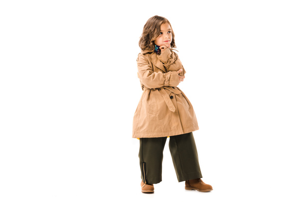 thoughtful little child in trench coat isolated on white - Foto, Imagem