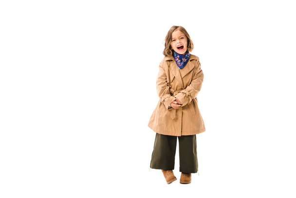 shouting little child in trench coat isolated on white - Fotó, kép