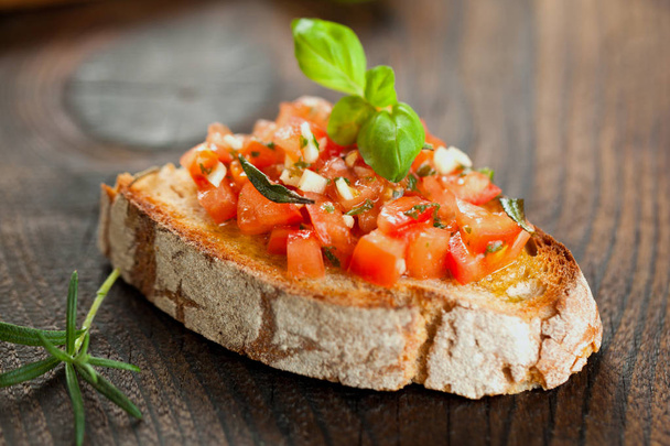bruschetta, on slices of toasted baguette garnished with basil - Zdjęcie, obraz