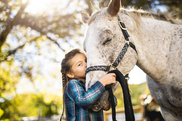 in a beautiful Autumn season of a young girl and horse - Foto, imagen