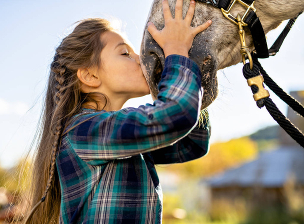 in a beautiful Autumn season of a young girl and horse - Foto, imagen