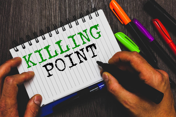 Handwriting text writing Killing Point. Concept meaning Phase End Review Stage Gate Project Evaluation No Go Man holding marker notebook paper communicating ideas Wooden background. - Photo, Image