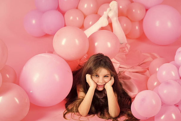 Funny little girl on background of bright pink wall - Valokuva, kuva