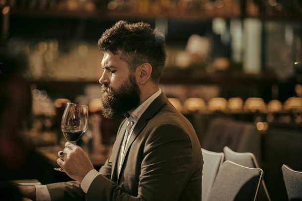 Man tasting wine in restaurant or bar interior - Fotoğraf, Görsel
