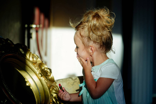 Kid model make up at mirror in room - Foto, Imagen