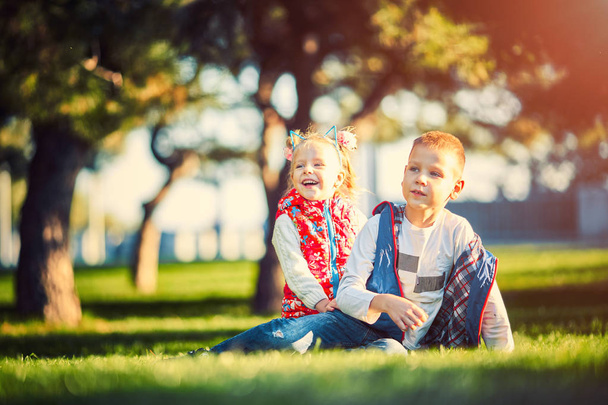 brother and sister in the park on the grass - Foto, Imagem