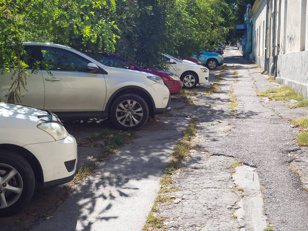 Car Parking on the broken sidewalk in Chisinau. - Photo, Image
