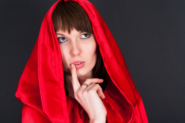 hermosa mujer en una túnica roja aislada en un negro
 - Foto, Imagen