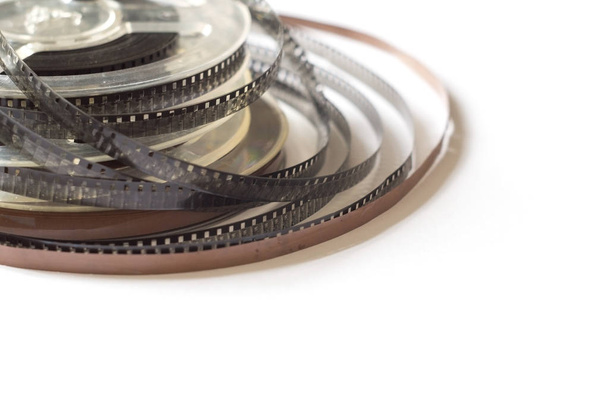 Old reels with a black and white film and magnetic tape - 写真・画像
