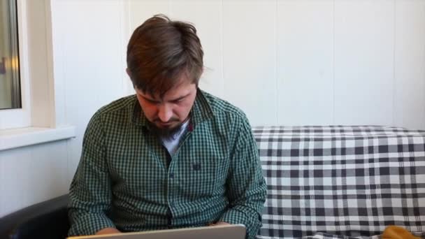 Young man, looks like a hipster, use laptop glad to received a welcome email, Good News - Footage, Video