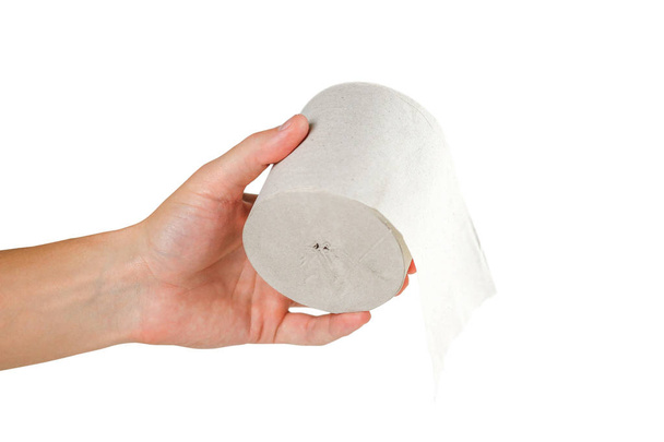 Hand holding toilet paper on white background. Close up. - Фото, изображение